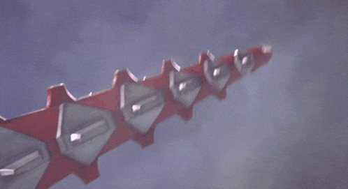 a toy robot is flying through the air with smoke coming out of it 's mouth