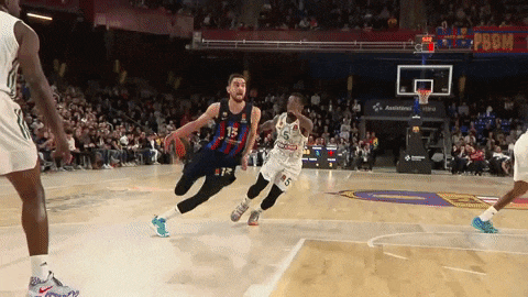 a basketball player wearing number 15 is dribbling the ball
