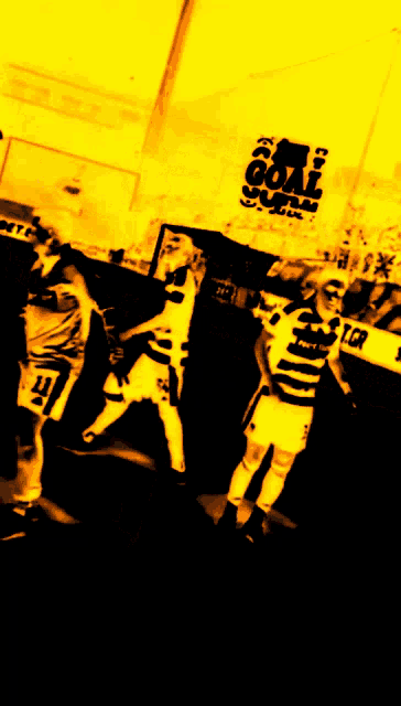 a group of soccer players in front of a sign that says goal soccer