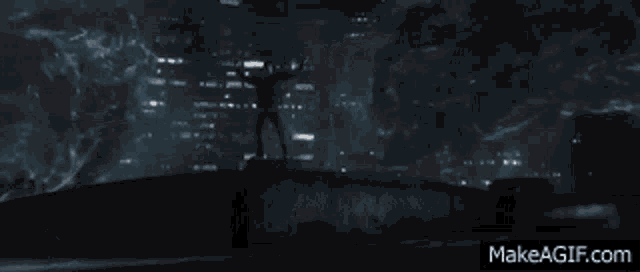 a person is standing in front of a building with a light coming out of their head .