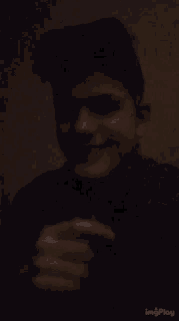 a blurry picture of a man 's face with the words imgplay visible in the corner