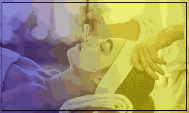 a woman is getting a facial treatment in a yellow frame