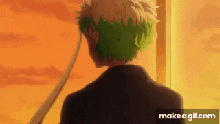 a man with green hair is standing in front of a window with a sunset in the background .