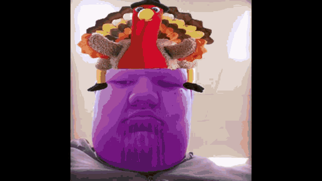 a man with a purple face and a stuffed turkey on top of his head