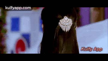 a close up of a woman 's back with a necklace on her neck .