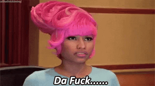 a woman with pink hair is wearing a blue shirt and saying `` da fuck '' .