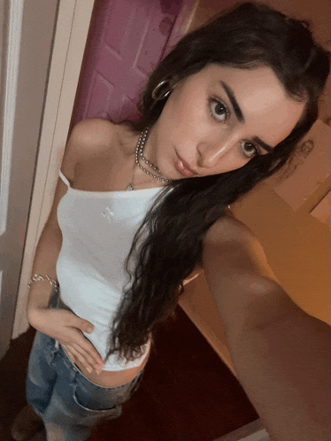 a woman taking a selfie in front of a door