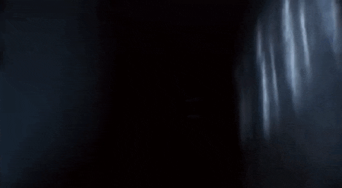 a silhouette of a person floating in the air in a dark room