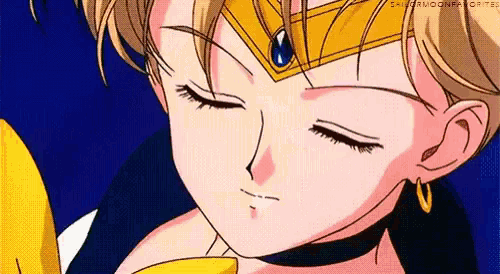 a close up of a girl 's face with her eyes closed and a crown on her head .