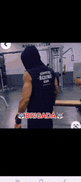 a man wearing a boxing vest is standing in a gym with the word brigada on the bottom