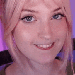 a close up of a woman 's face with her tongue hanging out .