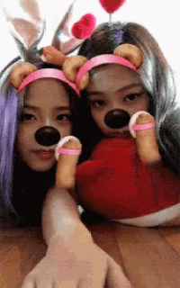 two girls wearing bunny ears and bear noses pose for a photo