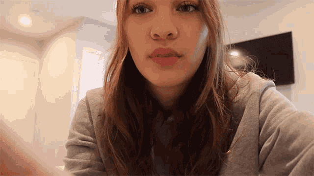 a close up of a woman 's face with her eyes closed