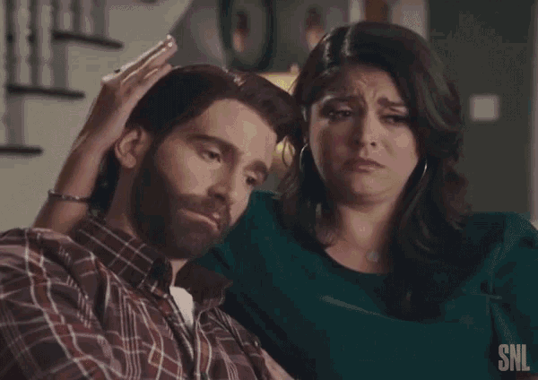 a man with a beard is being comforted by a woman who is crying and says sobbing