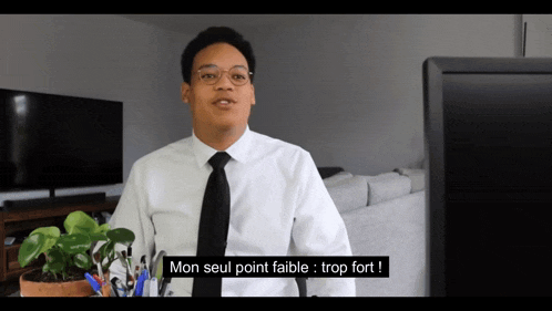a man in a white shirt and black tie says mon seul point faible
