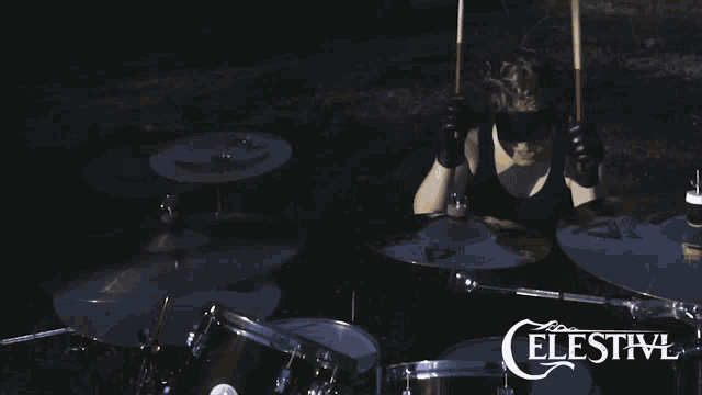 a celestivl poster with a person playing drums in the foreground