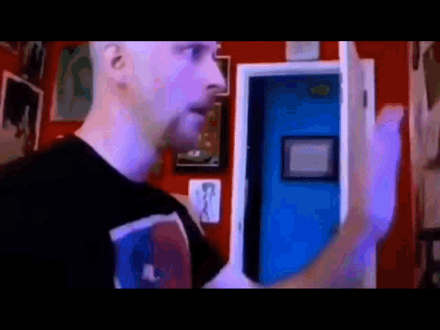 a man is standing in front of a blue door