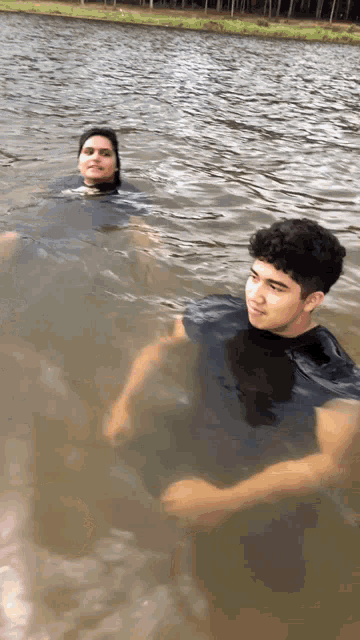 a man and a woman are floating in a lake