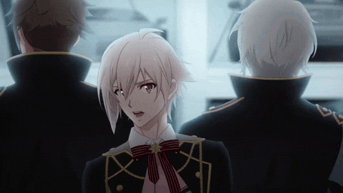 a man with white hair and a bow tie is standing in a dark room