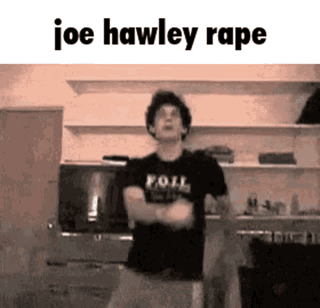 a man is standing in a kitchen with his arms crossed and the words `` joe hawley rape '' above him .