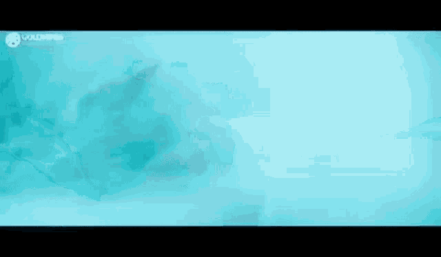 a silhouette of a person swimming in a pool with a blue background .