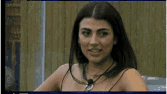 a close up of a woman wearing a necklace with a microphone on it