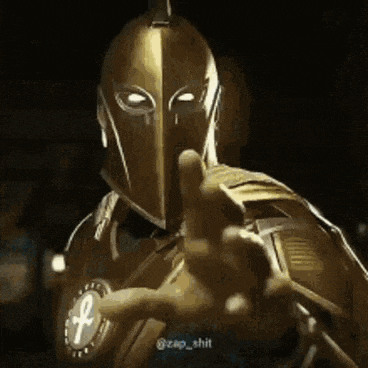 a man in a knight 's helmet is pointing at the camera .