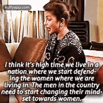 a woman is sitting on a couch with a quote about women