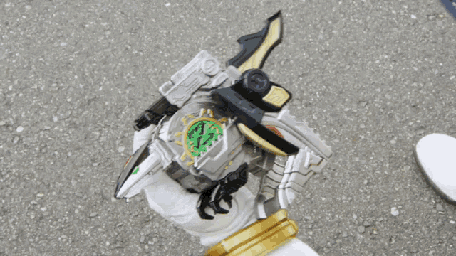 a person holding a toy that has a green emblem on it