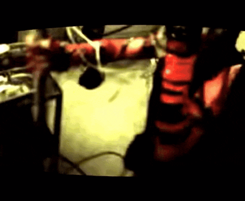 a blurred image of a person in a red shirt