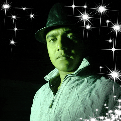 a man wearing a hat and a sweater is surrounded by sparkles