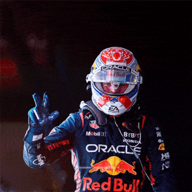 a man wearing a helmet with red bull on it