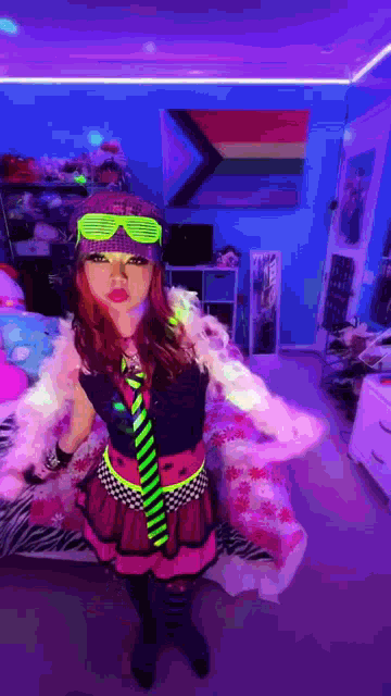 a woman in a neon outfit is standing in a bedroom with a rainbow flag on the wall .