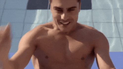a shirtless man is standing in front of a swimming pool