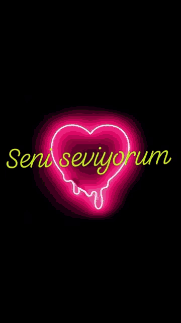 a neon sign in the shape of a heart with the words seni seviyorum dripping out of it .