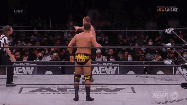 a wrestler with the word ego on his shorts is in the ring