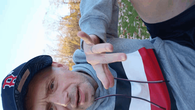 a man wearing a hat that says boston red sox on it