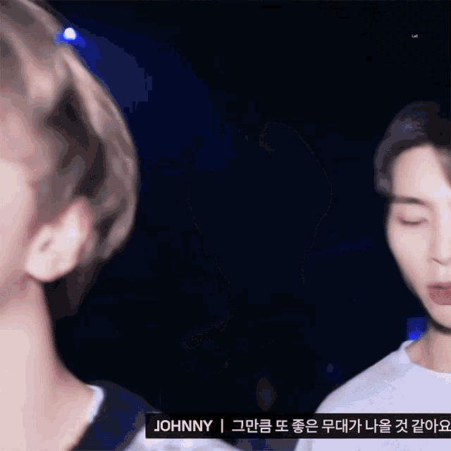 a close up of a person 's face with johnny written on the bottom right