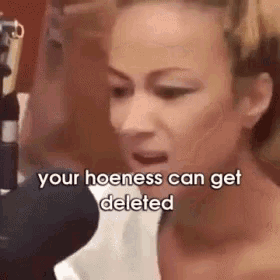 a woman is talking into a microphone with the words `` your hoeness can get deleted '' written next to her .