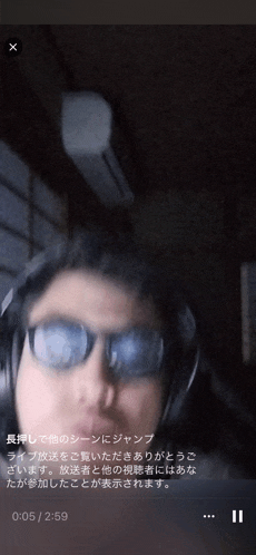 a video of a man wearing glasses and headphones is being played on a cell phone