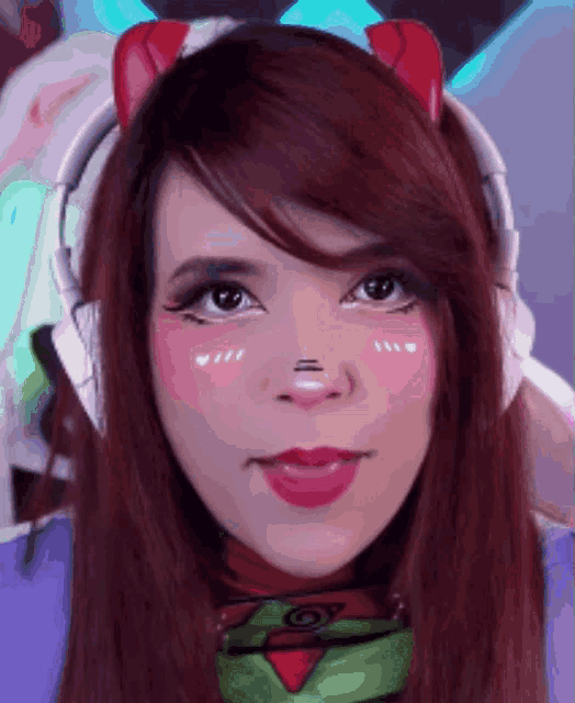 a close up of a girl wearing headphones and a cat ear headband