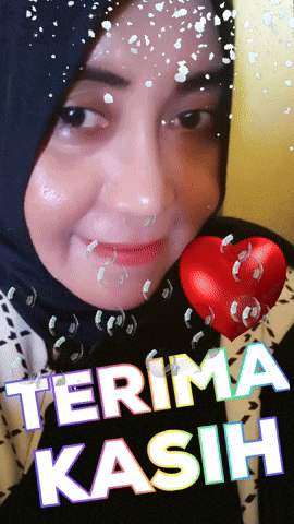 a woman in a black hijab is holding a red heart with the words terima kasih written on it