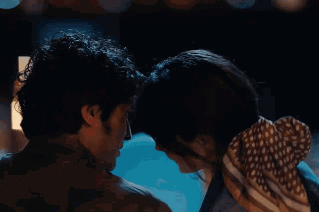a man and woman are looking into each other 's eyes