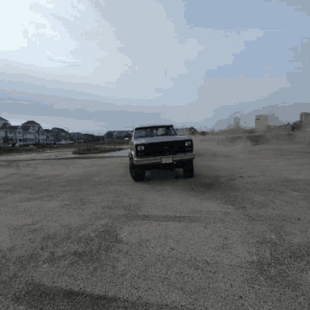 a silver truck with a new jersey license plate is driving through a dirt field