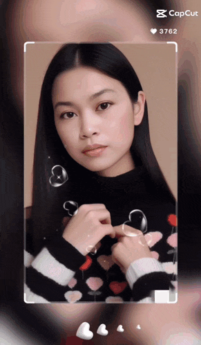a woman in a black and white striped sweater with hearts on it is shown on a screen that says cap cut