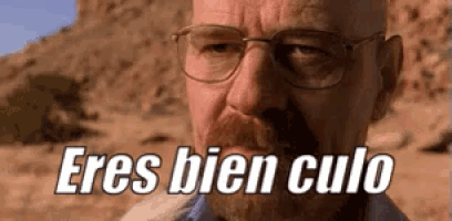 a man with glasses and a beard is looking at the camera and says eres bien culo .