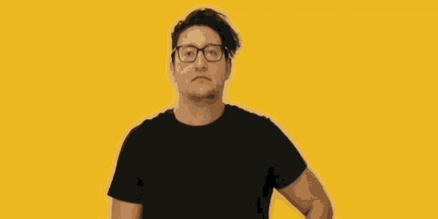 a man wearing glasses talking on a cell phone