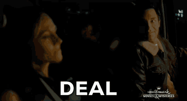 a man and a woman are sitting in a dark room and the word deal is on the bottom