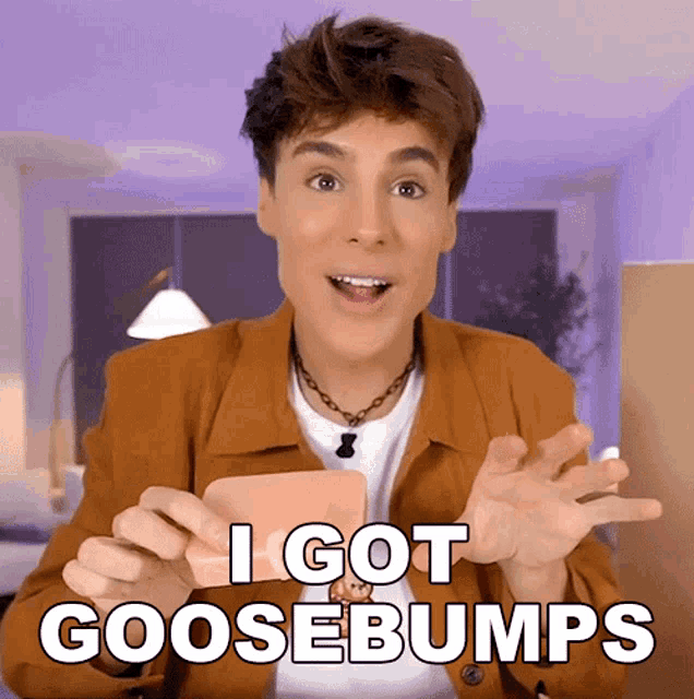 a man in a brown jacket is holding a card that says " i got goosebumps "
