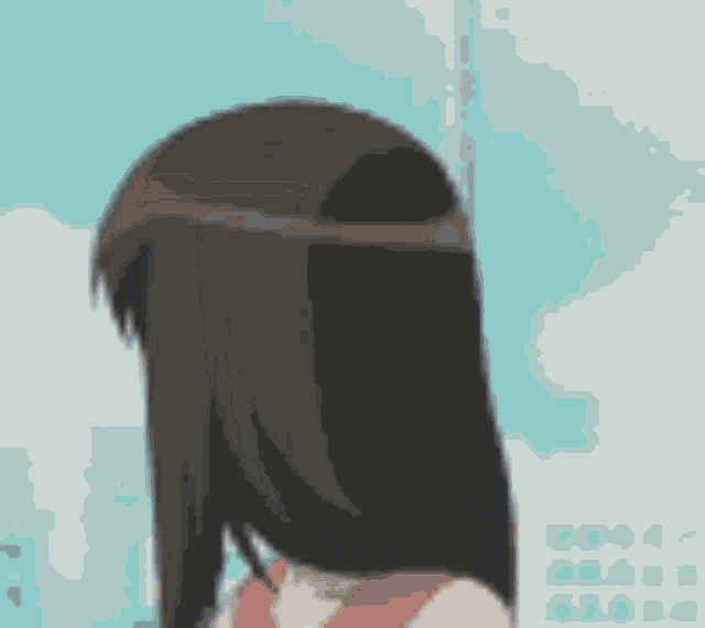 a girl with long brown hair is standing in front of a building .